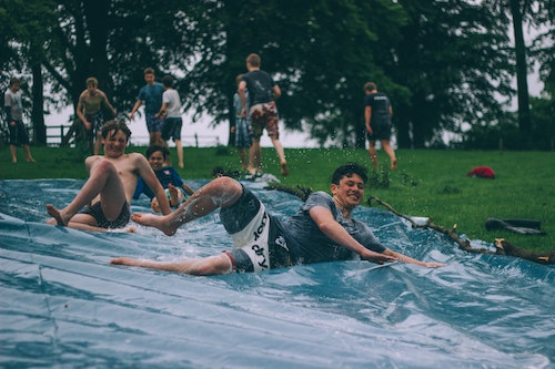 Kids sliding on a slip and play while camping