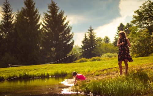 Sisters Fishing In A Pond