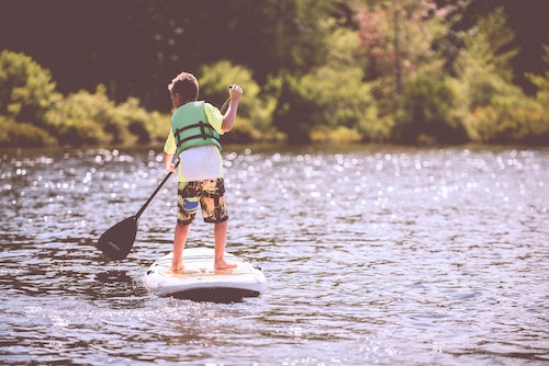 Young boy on a stand up paddle board